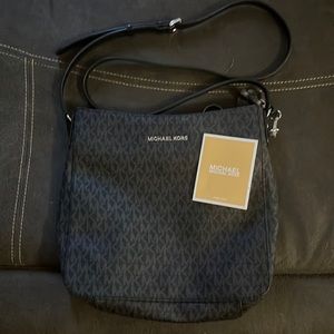 Michael Kors Jet Set large Messenger bag. Bag is black with light gray “K”s.
